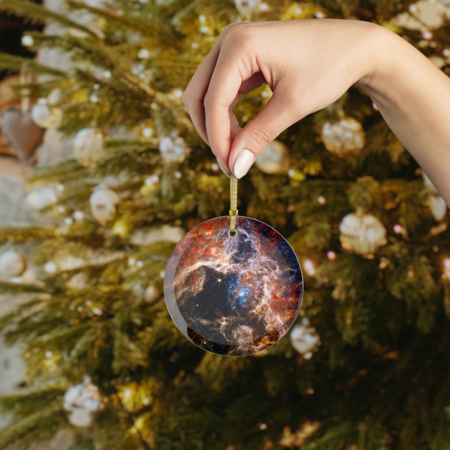 James Webb Tarantula Nebula glass Christmas ornament held in hand