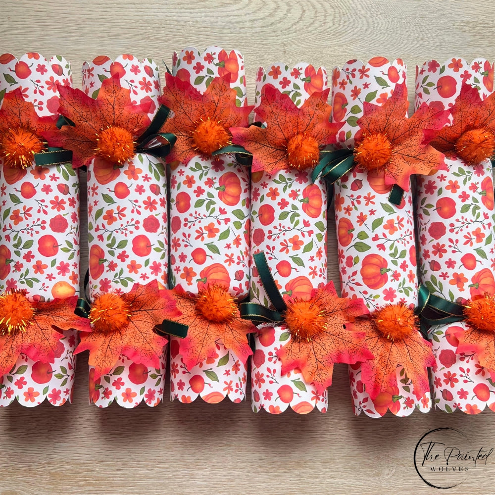Decorated fall and thanksgiving themed crackers with snaps and decorated with leaves, ribbons and bells perfect thanksgiving dinner favor or dinner party gift