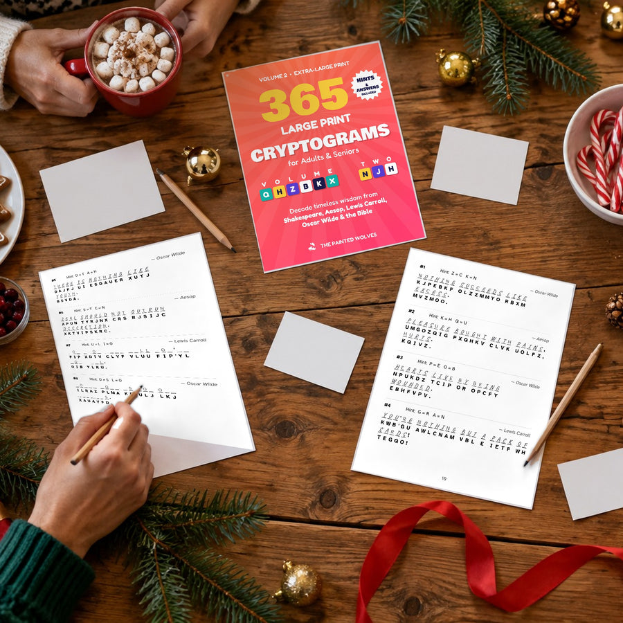 365 Large Print Cryptograms Volume 2 cover and real puzzle pages on a cozy holiday table with cocoa and a pencil