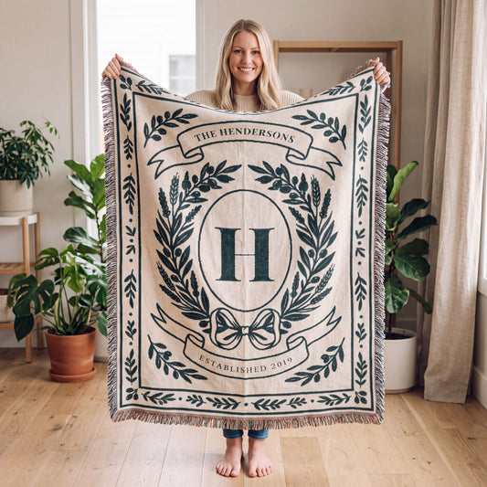 Woman holding up a 60x80 personalized family name woven throw blanket