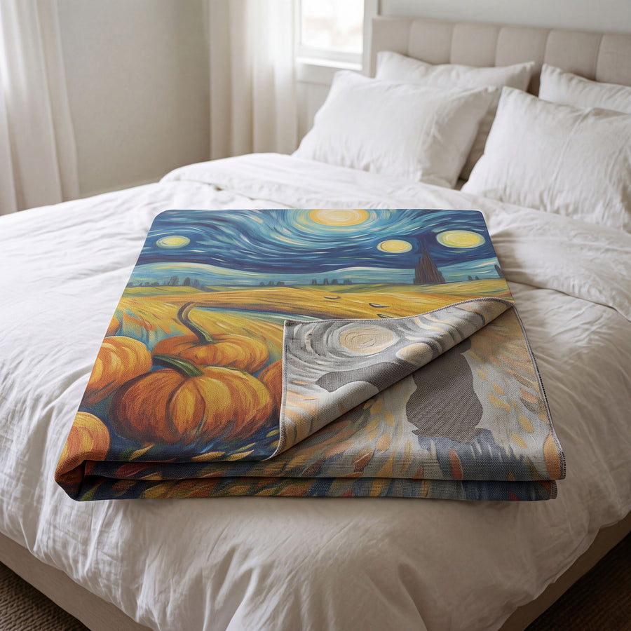 Van Gogh Halloween woven blanket folded on a bed with the reverse side showing