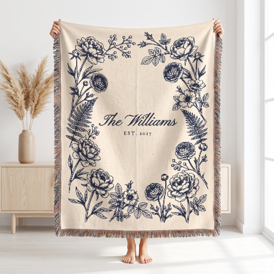 Navy family name woven blanket held up to show the 60 x 80 size