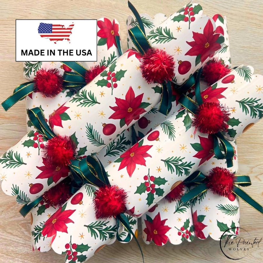 Handmade poinsettia crackers stacked to show the green ribbon ties at each end