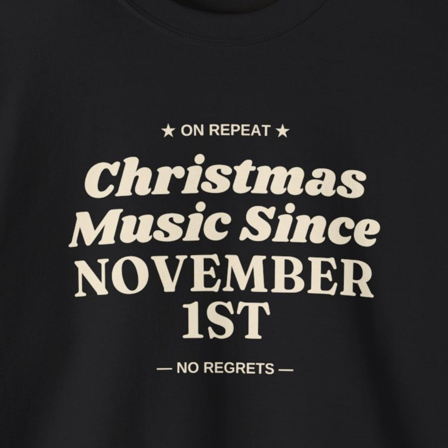 Close-up of the cream Christmas Music Since November 1st print on a black crewneck
