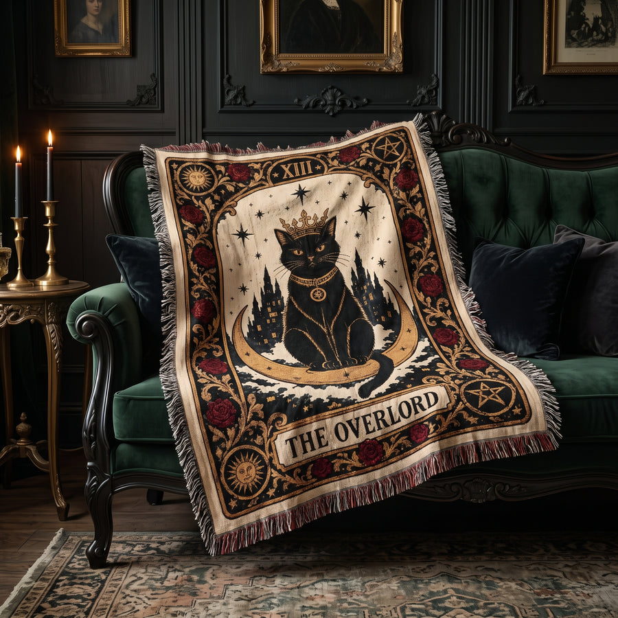 The Overlord black cat tarot woven blanket draped over a green velvet sofa in a gothic living room