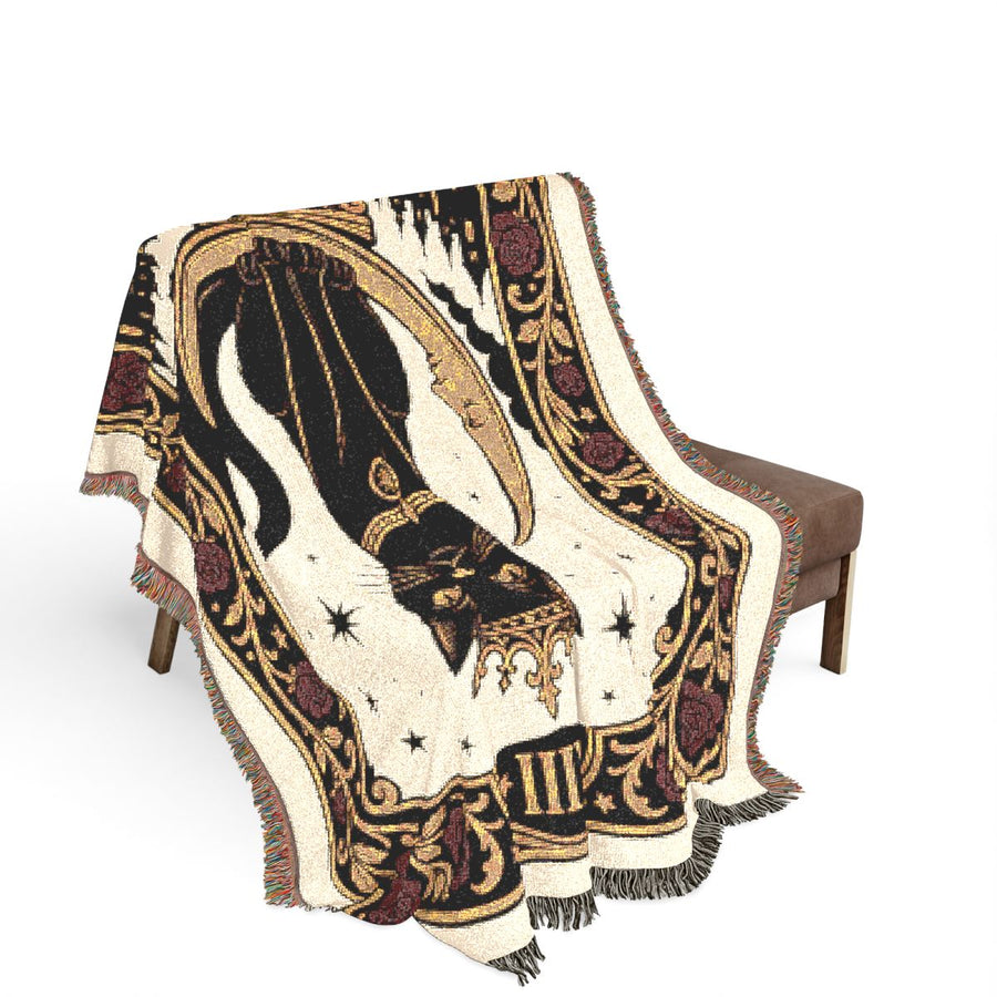 The Overlord woven blanket draped over a chair, showing how the tarot design falls