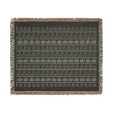 Fair Isle ghost and pumpkin woven blanket in a neutral living room