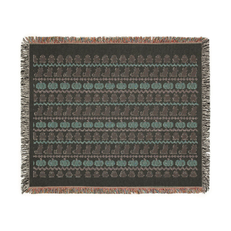 Fair Isle ghost and pumpkin woven blanket in a neutral living room