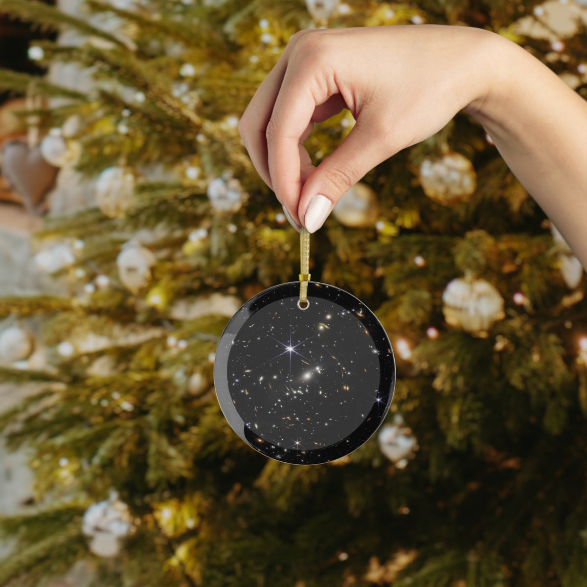 James Webb First Deep Field glass Christmas ornament held in hand