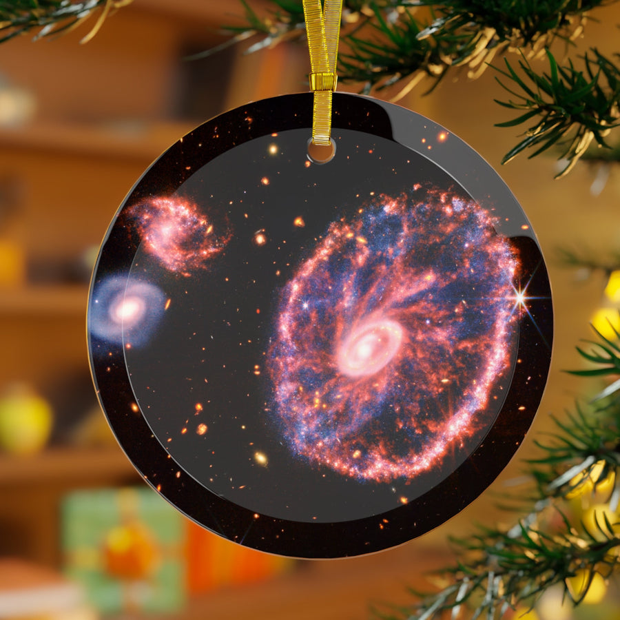 James Webb Cartwheel Galaxy glass Christmas ornament hanging on a Christmas tree