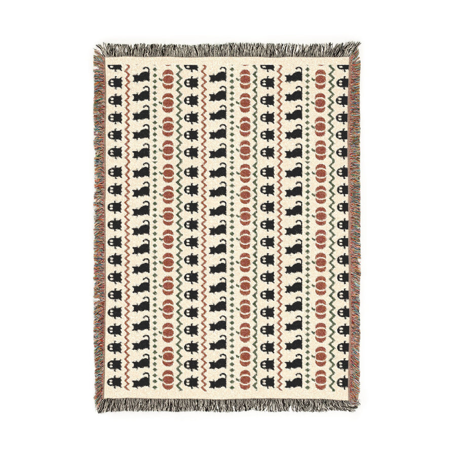 Beige Halloween Fair Isle blanket on a bed for subtle autumn decor