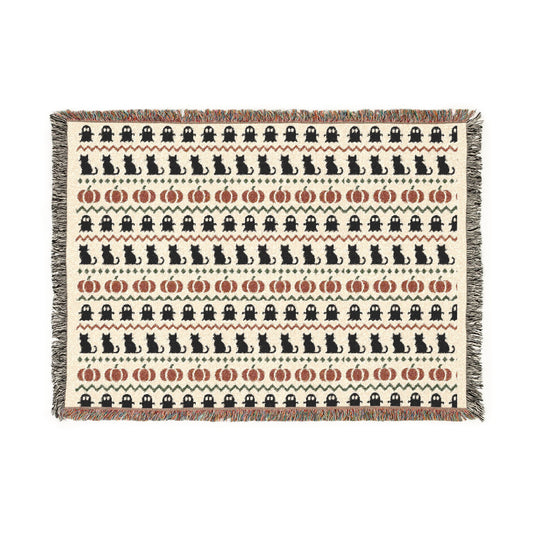 Neutral Halloween woven blanket with Fair Isle rows of ghosts, black cats and pumpkins in bone and rust