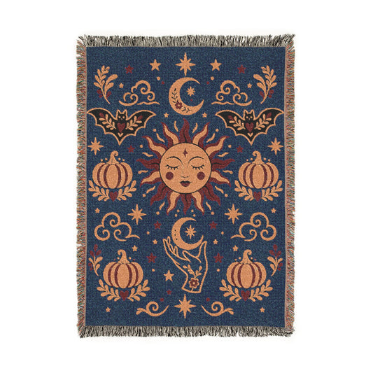Celestial woven blanket spread across a bed as whimsigoth bedding