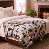 Black skull and roses woven blanket folded, showing the multi colour cotton weave