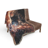 Corner detail of the Tarantula Nebula woven blanket showing the fringed edge