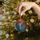 James Webb Pillars of Creation glass Christmas ornament held in hand