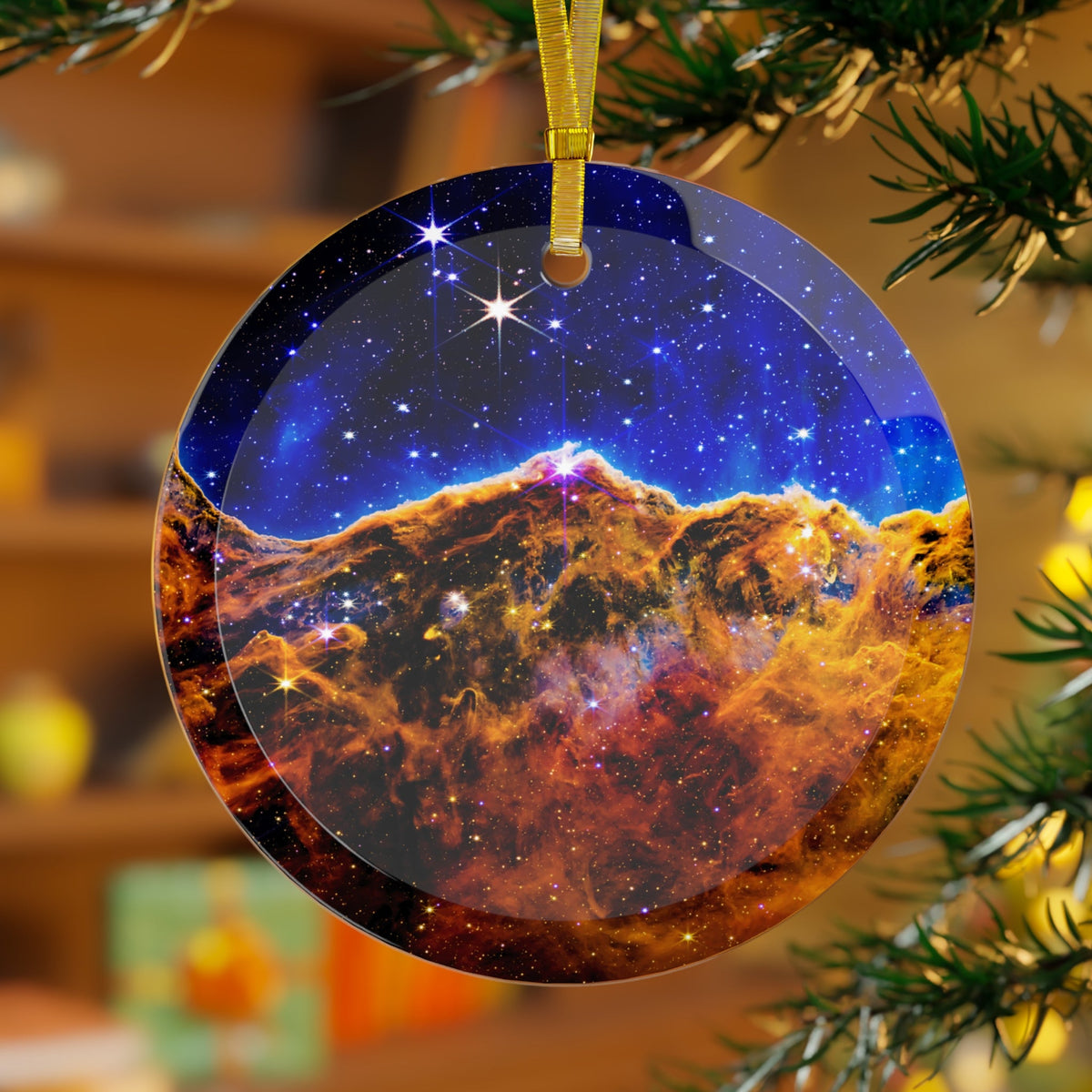 James Webb Carina Nebula Cosmic Cliffs glass Christmas ornament hanging on a Christmas tree