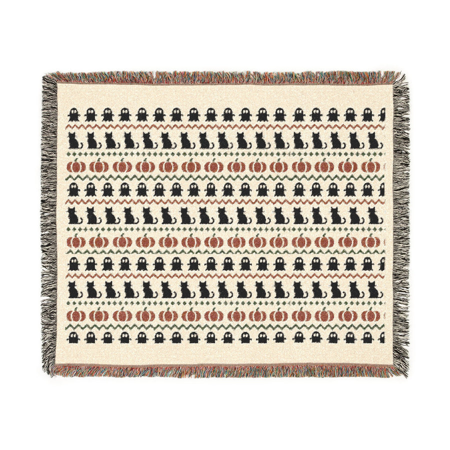 Close view of the woven cotton texture on the neutral Halloween blanket
