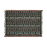 Neutral Halloween blanket hung on a wall as a Fair Isle tapestry