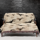 Bat woven Halloween blanket spread across a bed as a spooky season bedspread