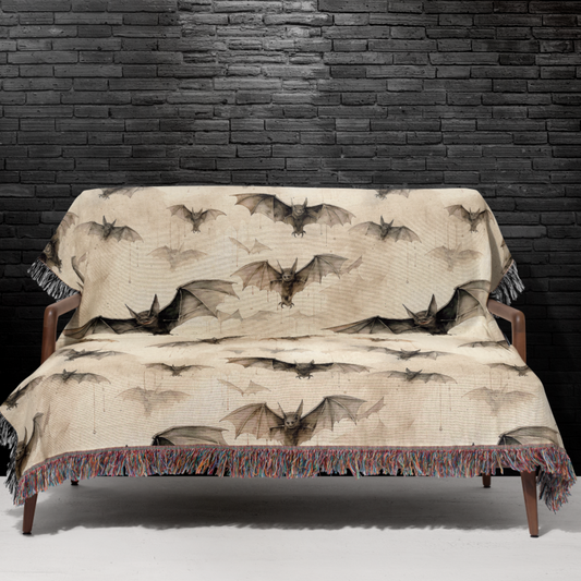 Bat woven Halloween blanket spread across a bed as a spooky season bedspread