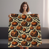 Woman holding the pumpkin and bat Halloween fleece blanket open, vintage jack o lanterns and bats