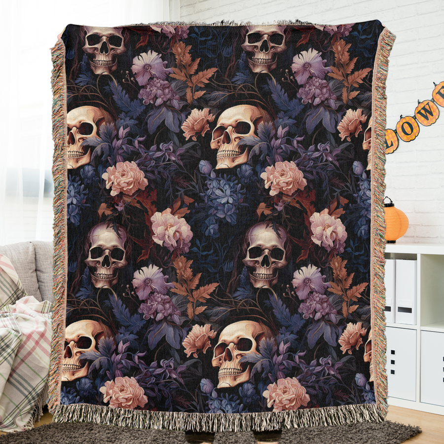 Skull woven blanket spread across a bed as Halloween bedding