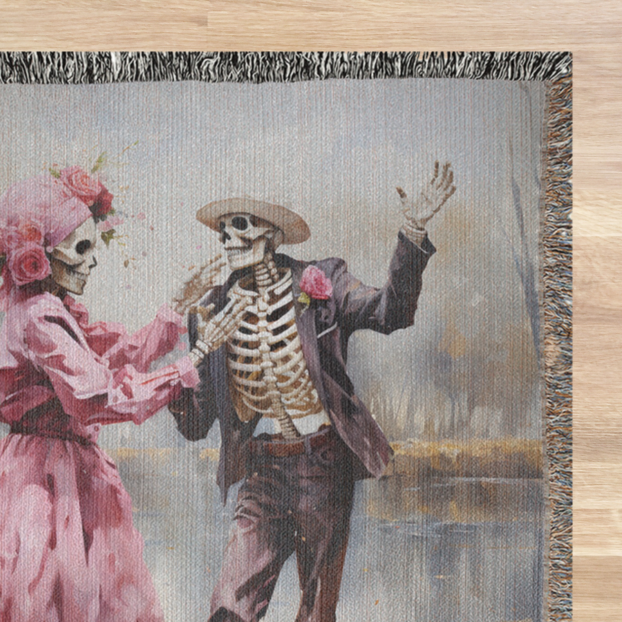 Pink skeleton couple woven blanket spread across a bed as spooky romantic bedding