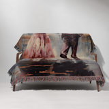 Person wrapped in the pink skeleton couple woven throw on a couch