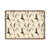 Bat woven blanket laid flat, cream cotton jacquard with a pattern of black bats and fringed edges