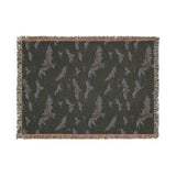 Reverse side of the bat woven blanket in dark charcoal with the bat pattern