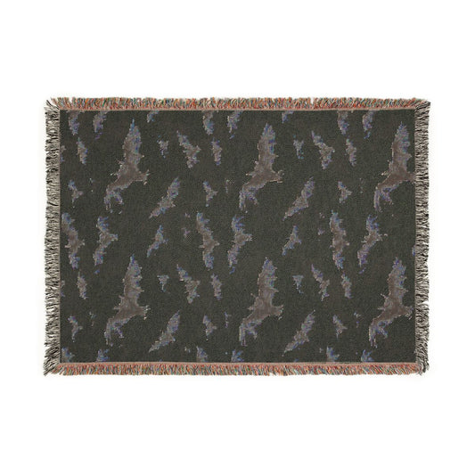 Reverse side of the bat woven blanket in dark charcoal with the bat pattern