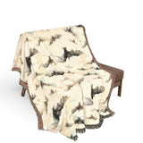 Bat woven blanket draped over a wooden chair on a white background