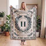 Woman holding up a 60x80 personalized family name woven throw blanket