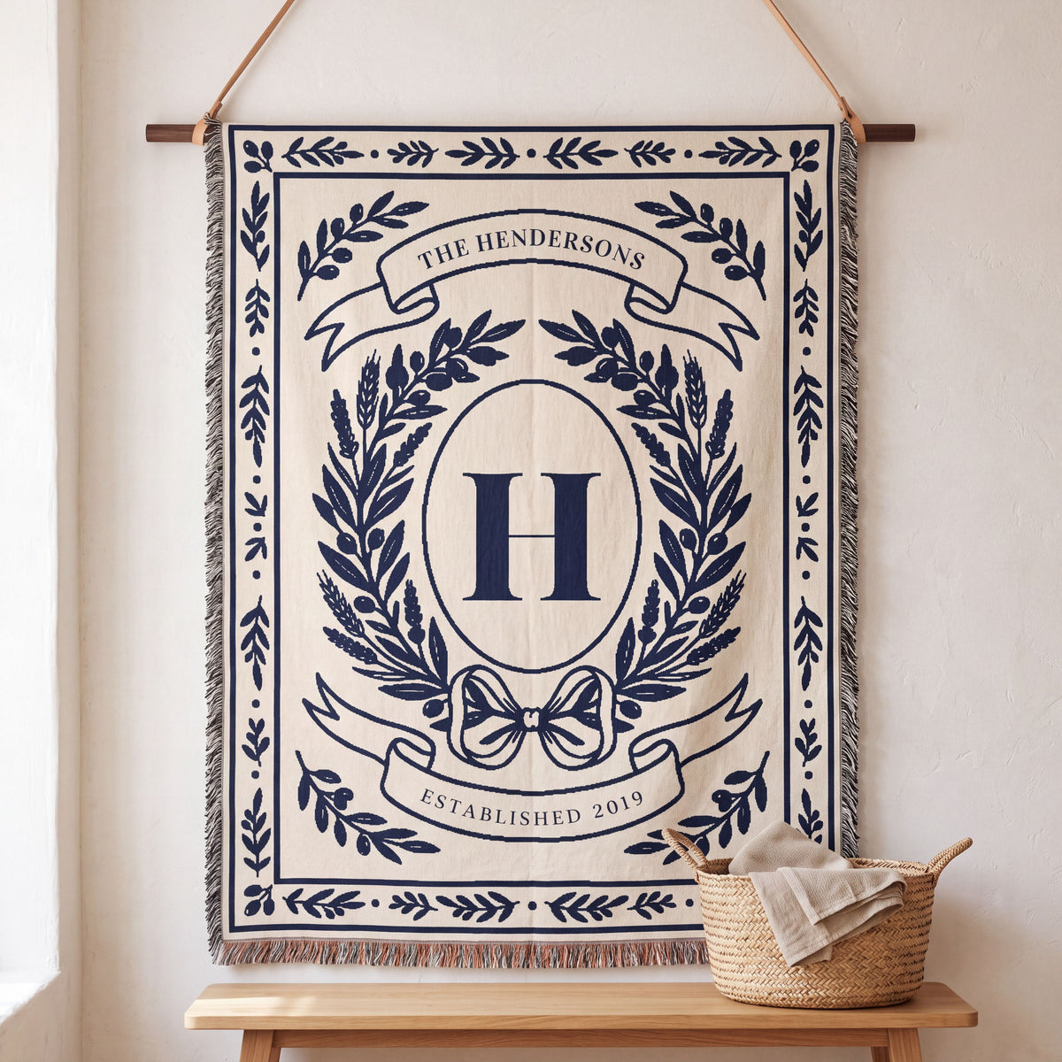 Navy personalized family crest woven blanket hanging on a wall