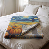 Van Gogh Halloween woven blanket folded on a bed with the reverse side showing