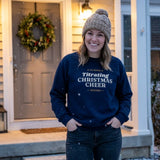 Woman on a snowy front step in the Navy Titrating Christmas Cheer ICU nurse crewneck