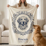 Woman holding up a custom Toile-style pet portrait blanket of her golden retriever Biscuit while he looks up at it