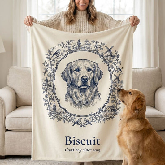 Woman holding up a custom Toile-style pet portrait blanket of her golden retriever Biscuit while he looks up at it