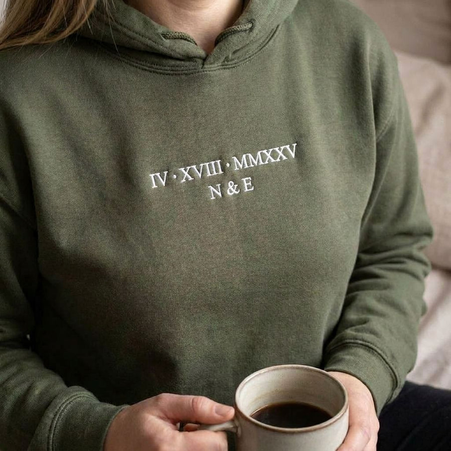 Military green Roman numeral hoodie with IV XVIII MMXXV and N & E embroidered in white thread
