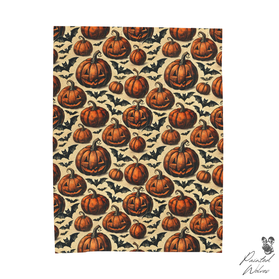 Pumpkin and bat Halloween fleece blanket shown flat on white, full vintage pumpkin repeat