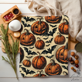 Close view of the pumpkin and bat fleece on a table with herbs, showing the plush pile