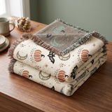 Subtle Spooky woven blanket folded with one corner turned back to show the muted reverse side of the jacquard weave