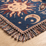 Close up of the woven cotton weave and knotted multicoloured fringe on the celestial sun and moon blanket