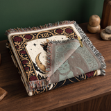 The Overlord woven blanket folded with one corner turned back to show the muted reverse side of the jacquard weave