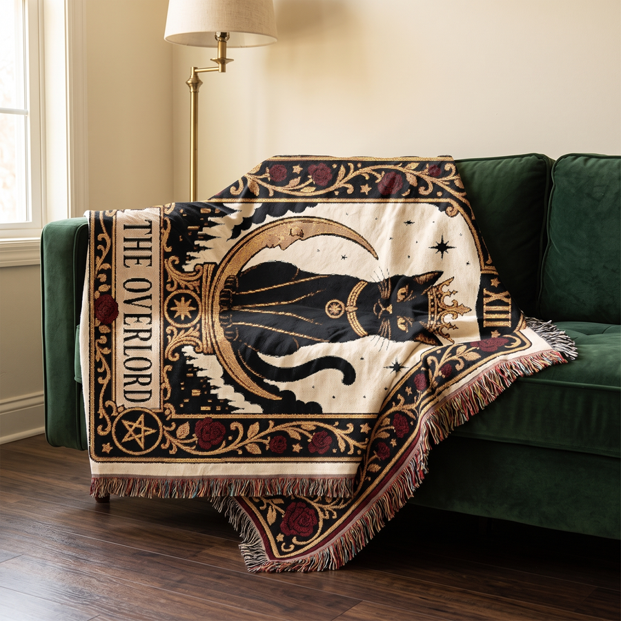 Black cat tarot woven throw draped over a deep green velvet sofa in a gothic styled room