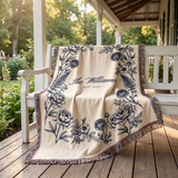 Navy family name woven blanket draped on a porch bench