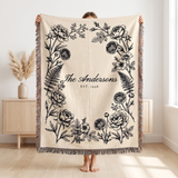 Black family name woven blanket held up to show the 60 x 80 size