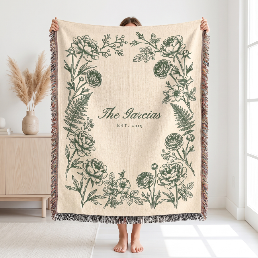 Sage family name woven blanket held up to show the 60 x 80 size