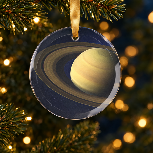 Saturn glass Christmas ornament hanging on a Christmas tree